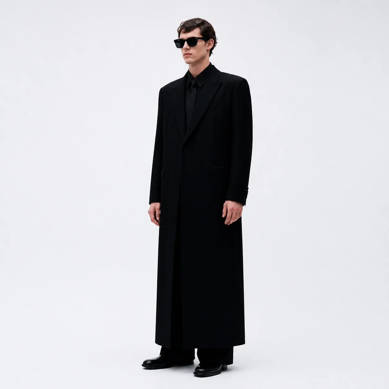 Style key frame — black tailoring against a light seamless backdrop